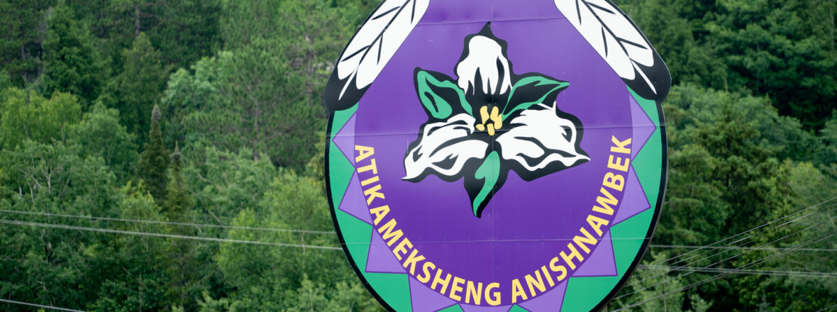 Billboard with Atikameksheng Anishnawbek logo
